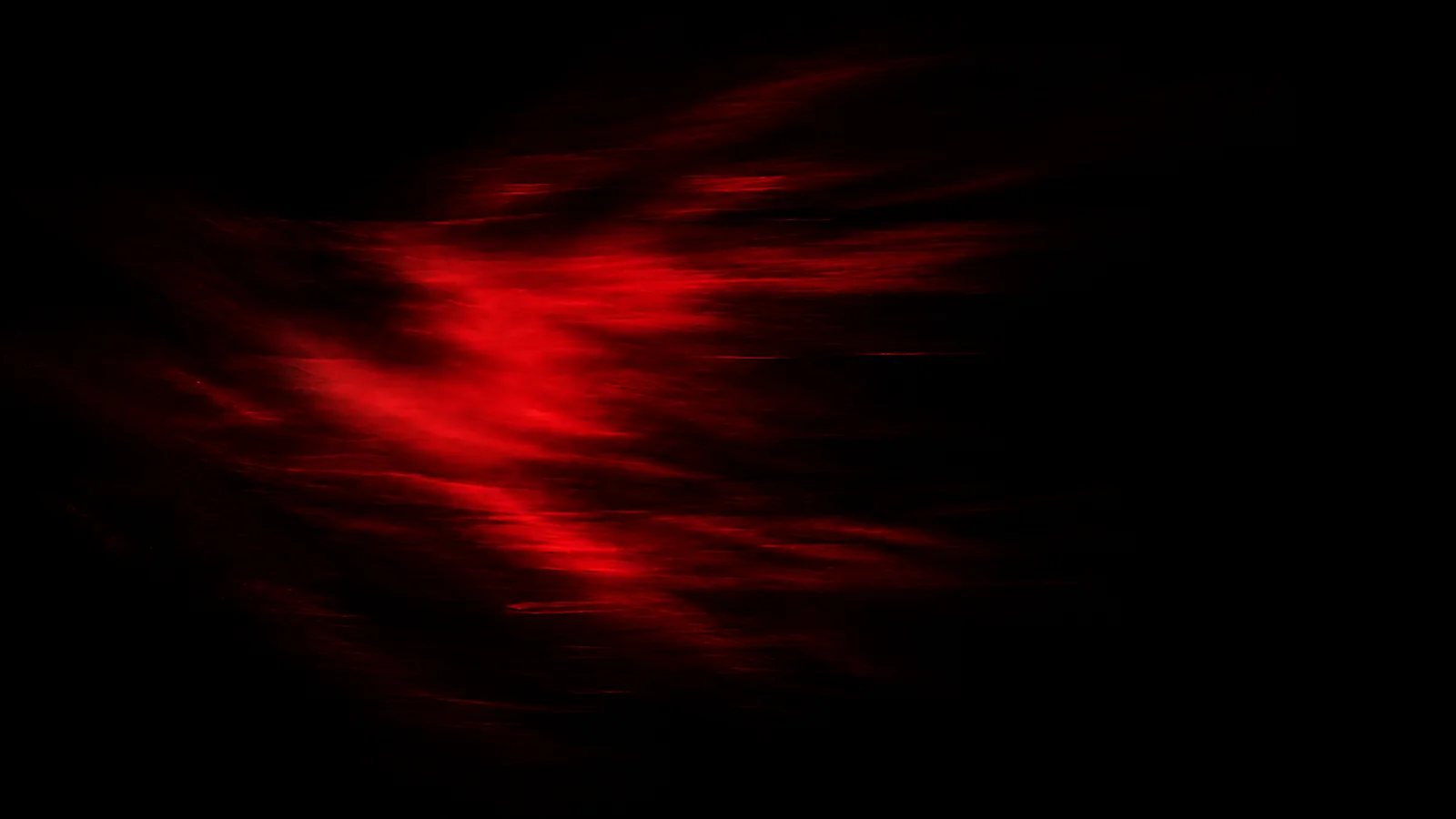 A red light trail moving through a dark space